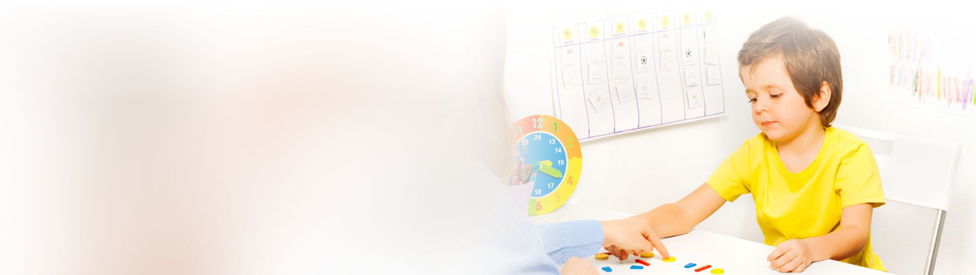 Boy putting colorful shaped coins