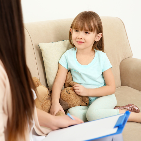 Young child psychologist working with little girl