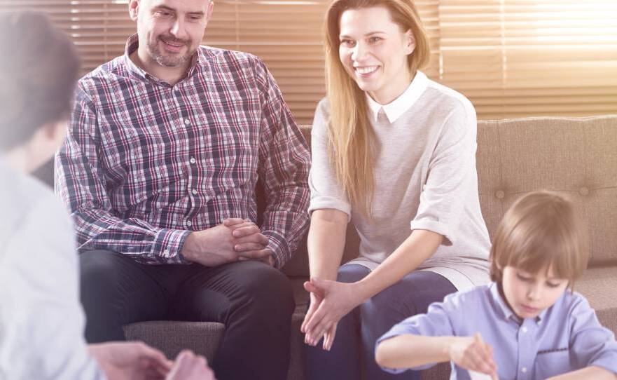 happy family talking to a therapists for their child